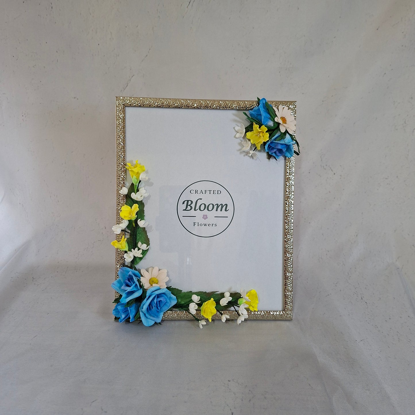 Handmade blue and yellow floral photo frame decorated with artificial flowers for kids and memory photos and home decor