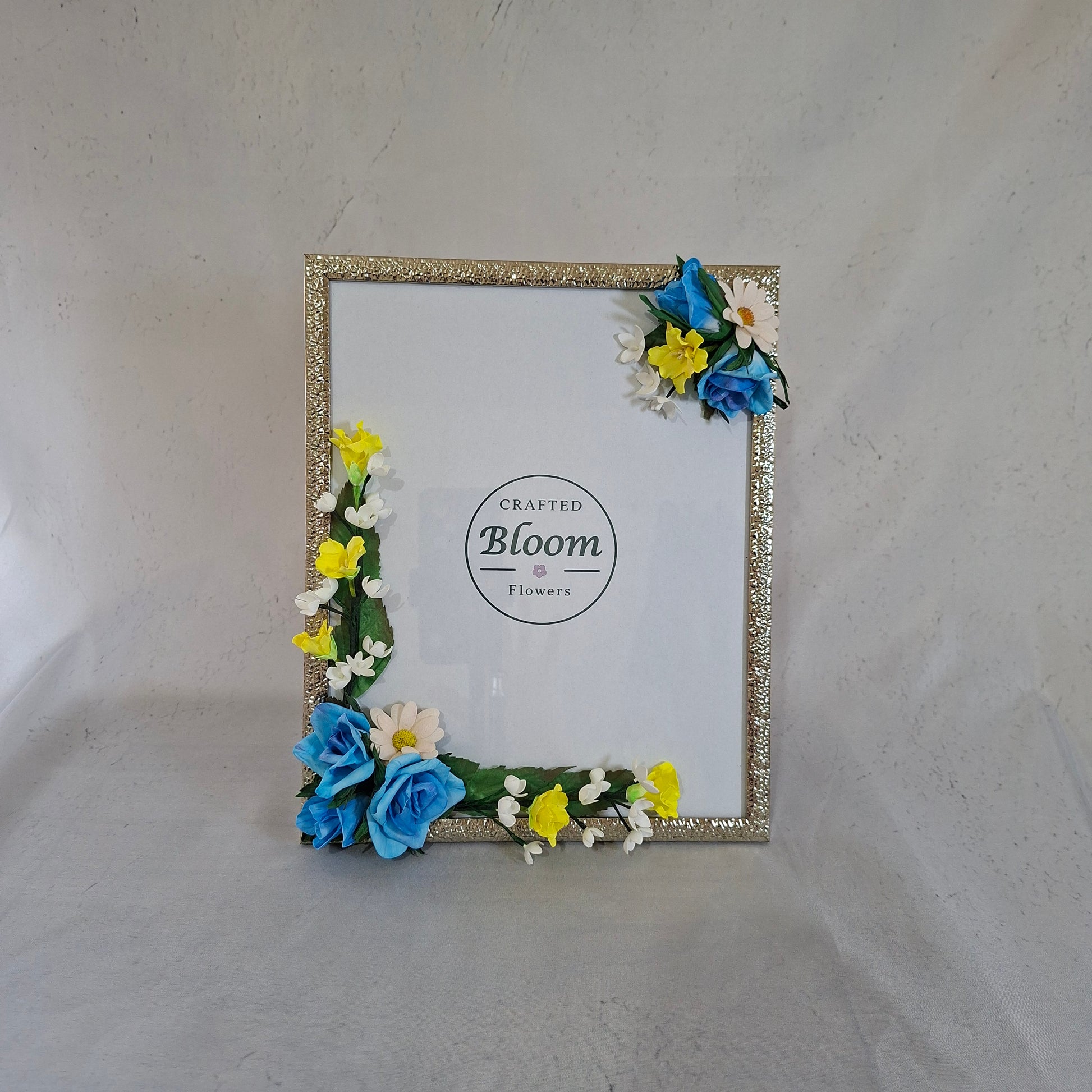 Handmade blue and yellow floral photo frame decorated with artificial flowers for kids and memory photos and home decor