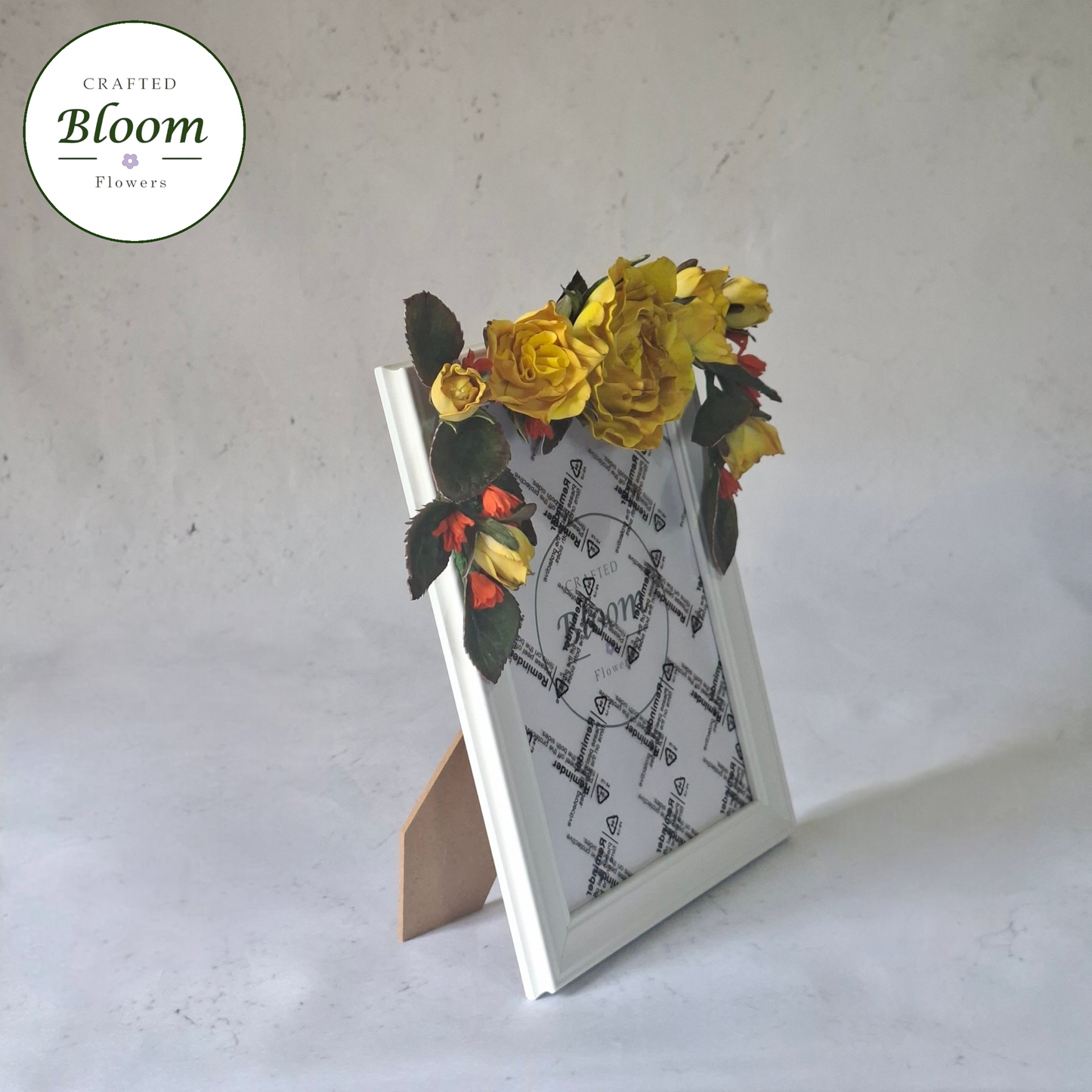 white picture frame decorated with yellow  roses and green foliage on top, Crafted Bloom Flowers