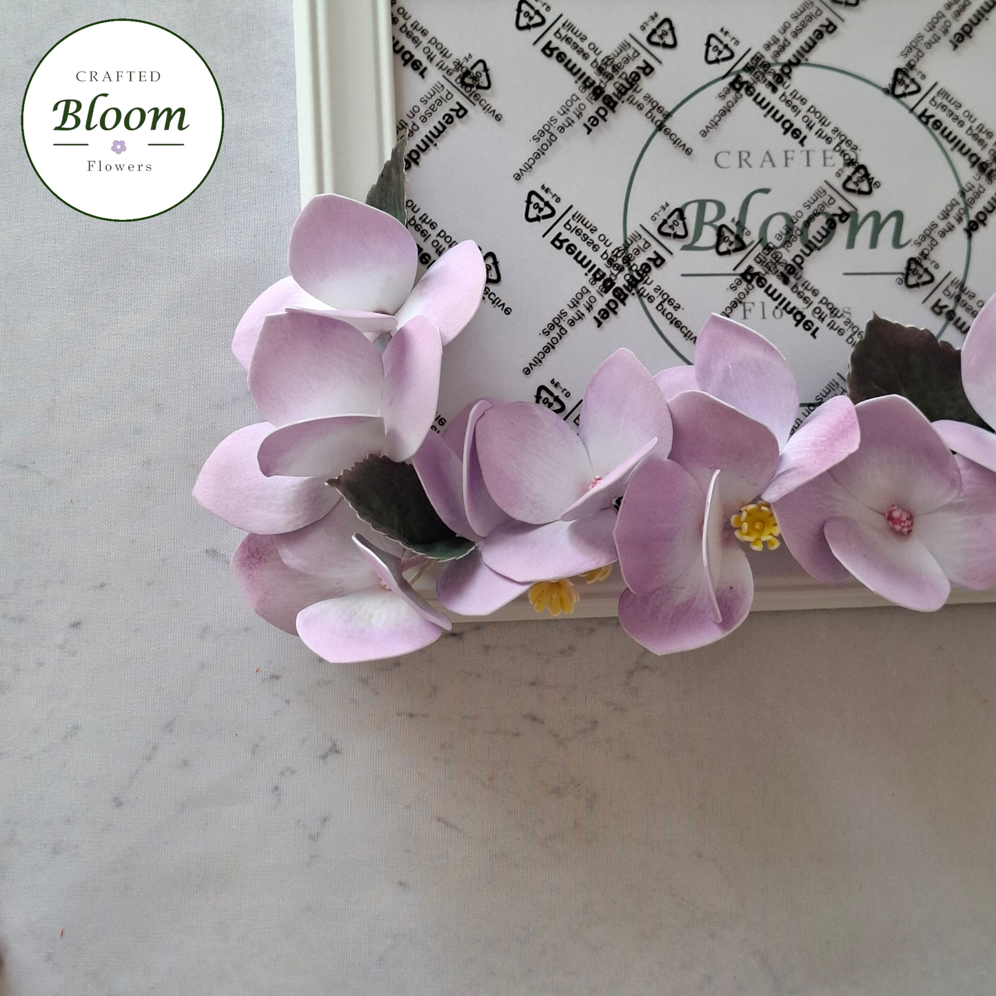 Close-up of handmade foamiran hydrangea flowers on picture frame