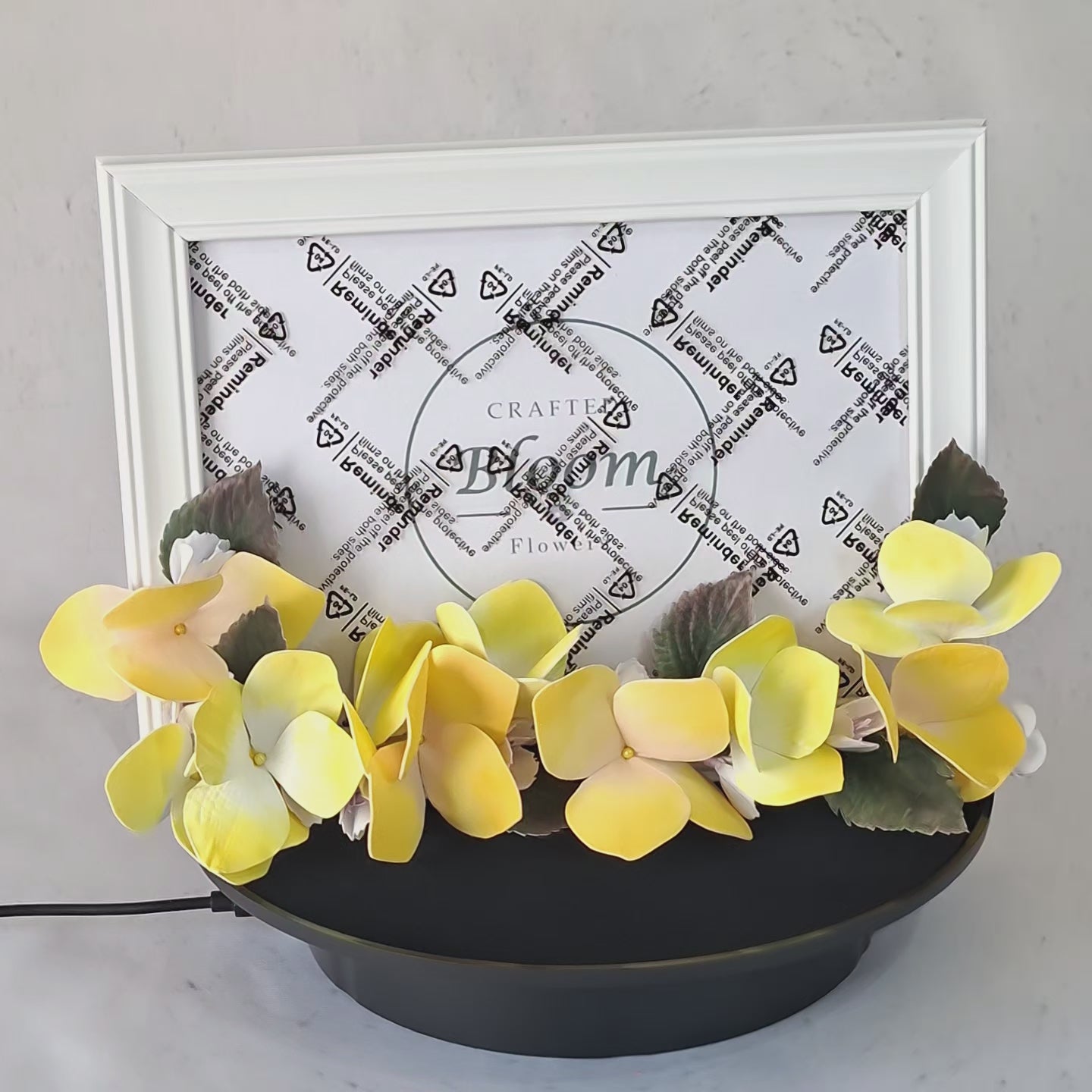 Yellow foamiran hydrangea photo frame on white shelf